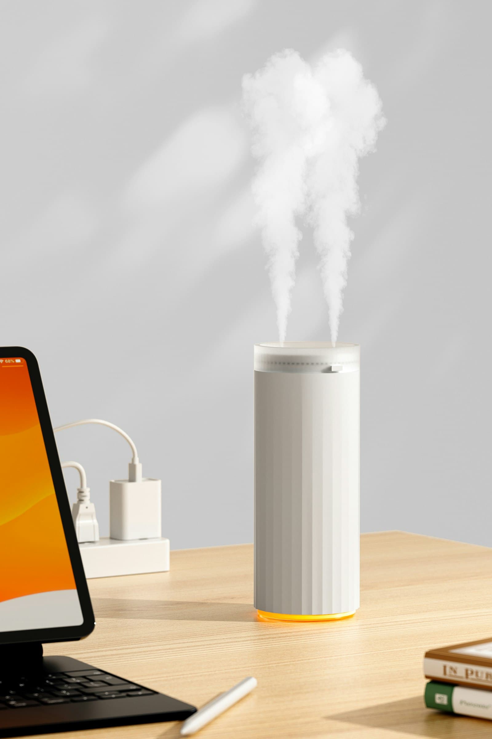 White humidifier releasing mist on a bright wooden desk