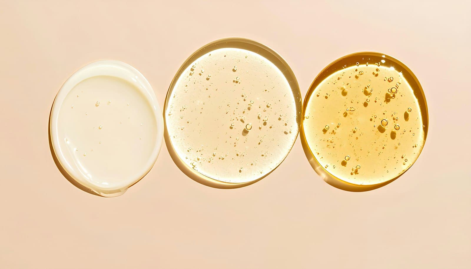 Three skincare swatches in a row on a peach background: milky lotion, clear gel and golden oil