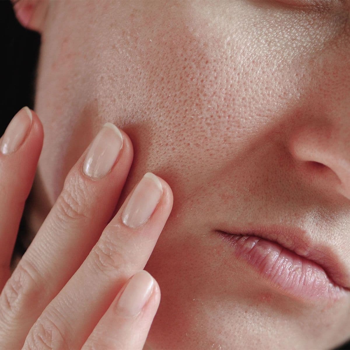 Close-up of a nose, lips and chin showing natural skin texture and pores