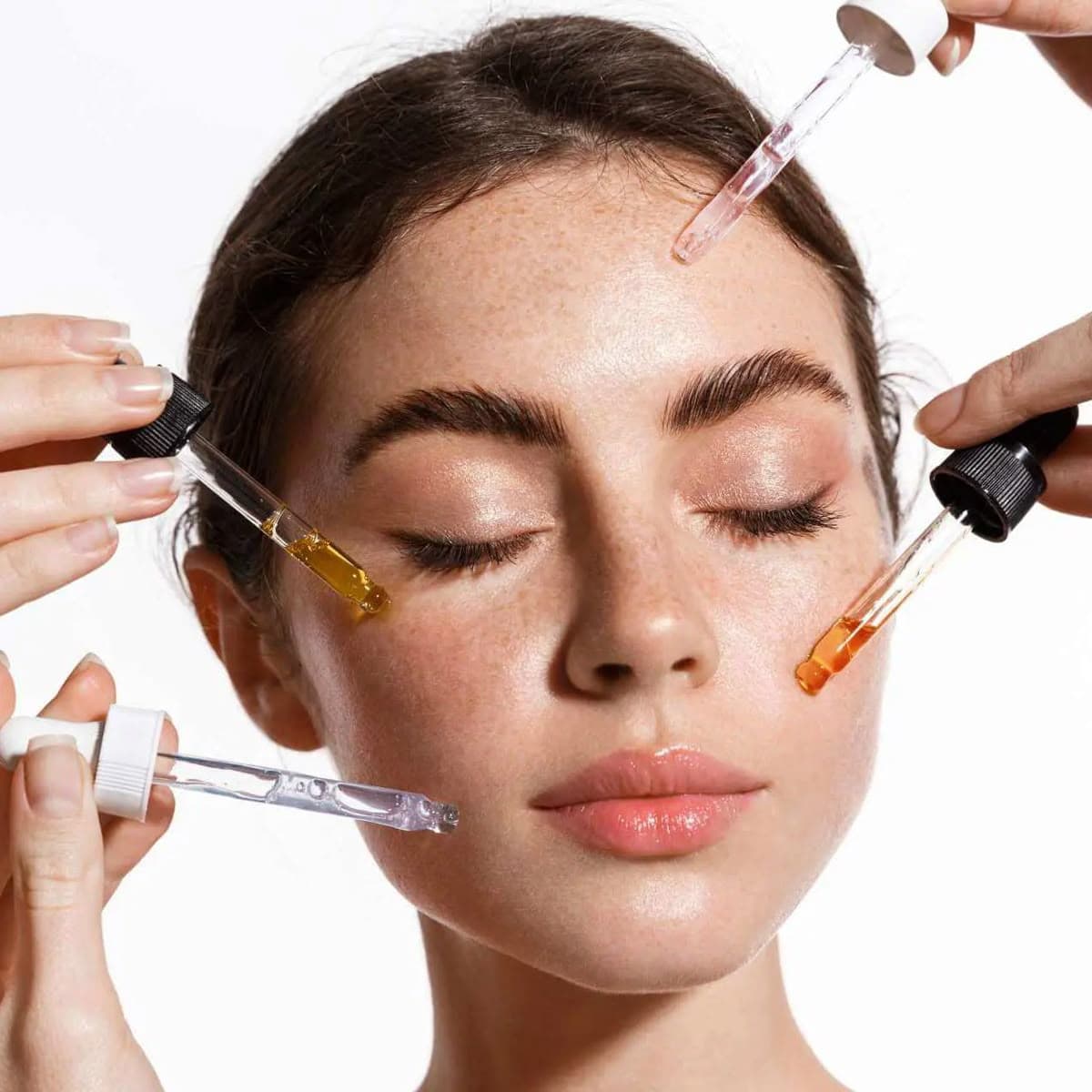 Woman gently smoothing a dab of moisturizer onto her cheek